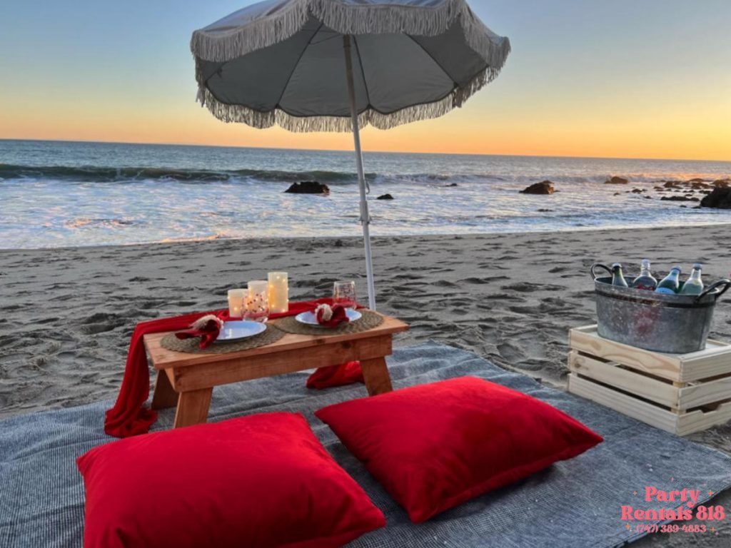 Picnic at the Beach with Pillows Umbrella and Sweetheart Table