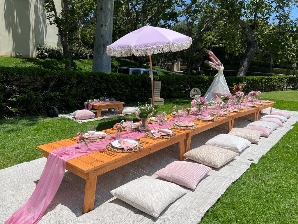 Picnic Setup in Beverly Hills with Picnic Table, Pink Runner, Pink Napkins, Cutlery, Plates, Placemat and Flower Centerpiece